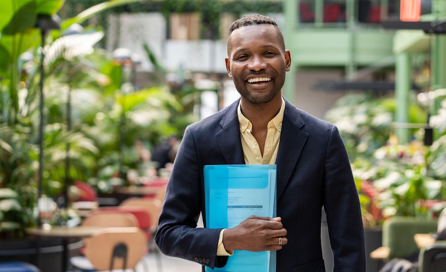 Happy man in plant filled office
