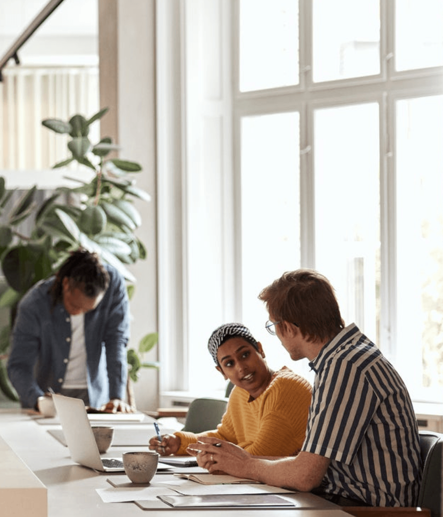 Coworkers interacting in bright office