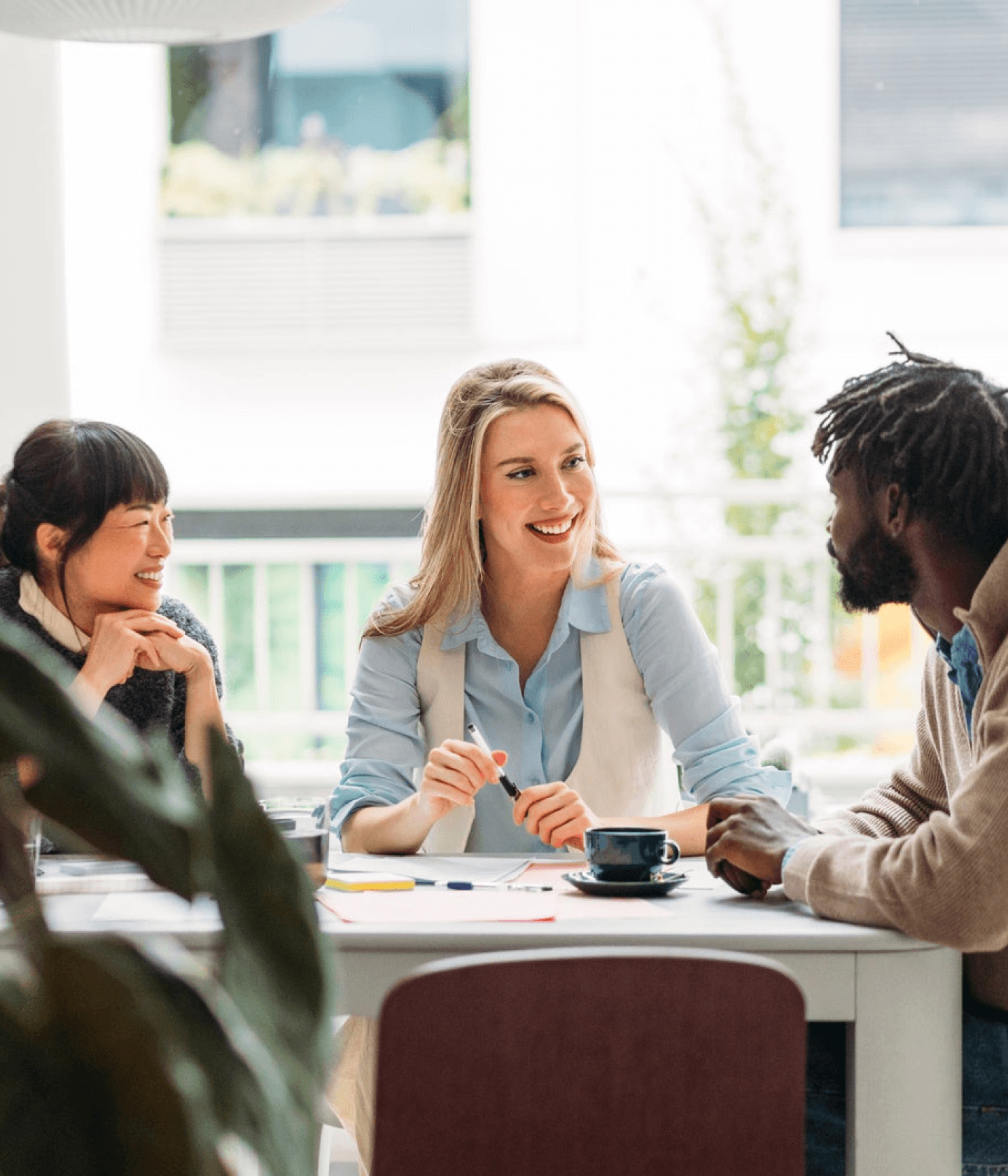 Group of co workers conversing at a table