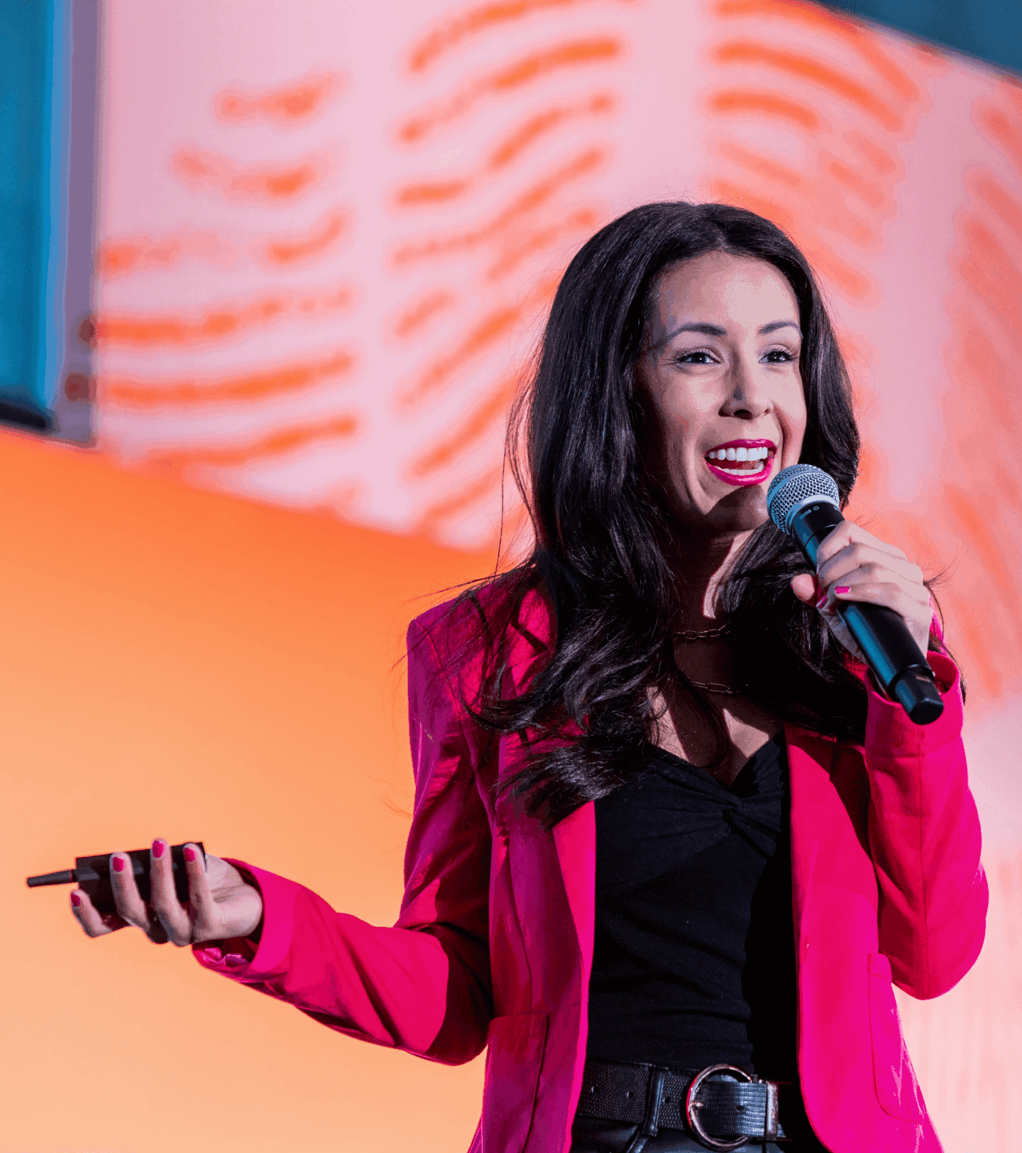 Woman in brightly colored jacket on stage speaking at Open desktop